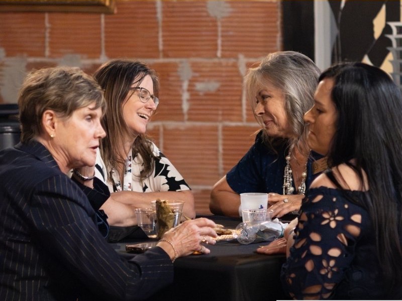 Guests sharing a conversation at a whiskey gathering